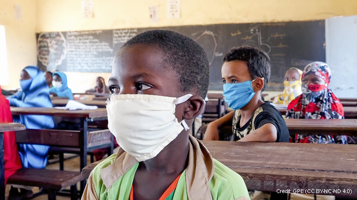 Primary age children in classroom in Niger, wearing masks