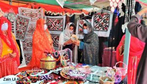 Colorful decorated tapestries and handicrafts at a market stall
