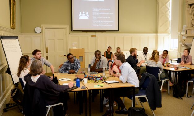 workshop at UKFIET Conference 2019 with groups sitting around tables in discussion.