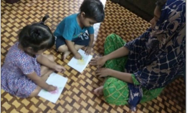 Mother playing with children at home