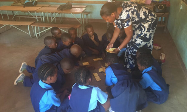 A teacher engages students through play in the classroom in Zambia