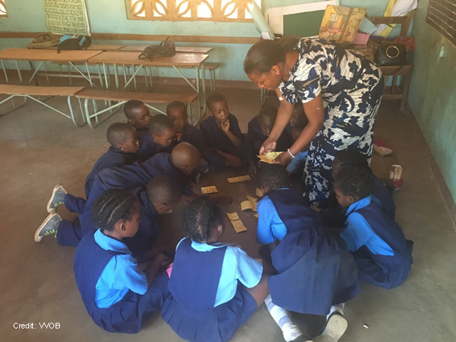 A teacher engages students through play in the classroom in Zambia