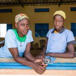 Two teenage girls at their classroom window, Niger.