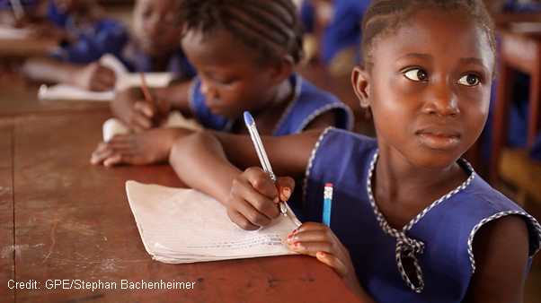 Girl writing in her notebook in class, Sierra Leone