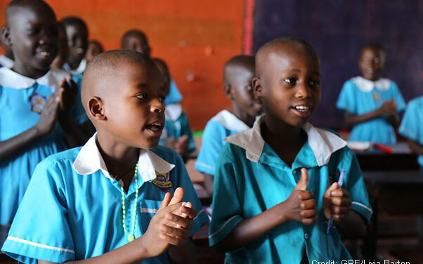 Children singing in the classroom of a primary school, Uganda