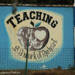 Sign reading ‘Teaching is a work of the heart’ on the wall of Freetown Teacher’s College, Sierra Leone.
