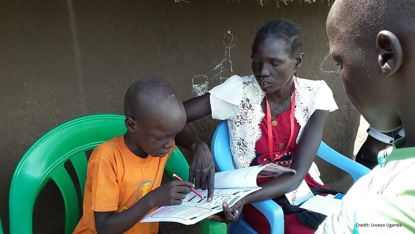 South Sudanese volunteers assess a child's reading