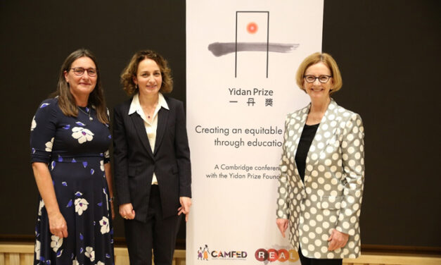 Pauline Rose from the REAL Centre, Lucy Lake from CAMFED and the Honourable Julia Gillard stand in front of a conference banner for the Yidan Prize Foundation conference organised by the REAL Centre and CAMFED on 7 October 2021.