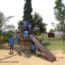 A group of primary students play in the school playground on slide and climbing frame, Eureka Program, Tamil Nadu,