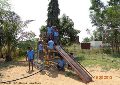 A group of primary students play in the school playground on slide and climbing frame, Eureka Program, Tamil Nadu,