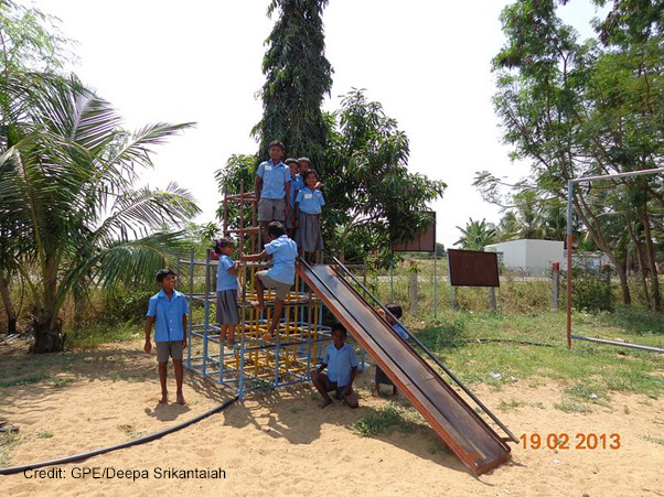 A group of primary students play in the school playground on slide and climbing frame, Eureka Program, Tamil Nadu,