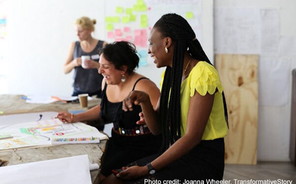 Alison Buckler in the background and Nava Derakhshani and Jennifer Agbaire laugh over some visual storytelling aides during a workshop.