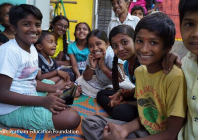 Children in Anekal, Karnataka accessing digital content on a tablet.