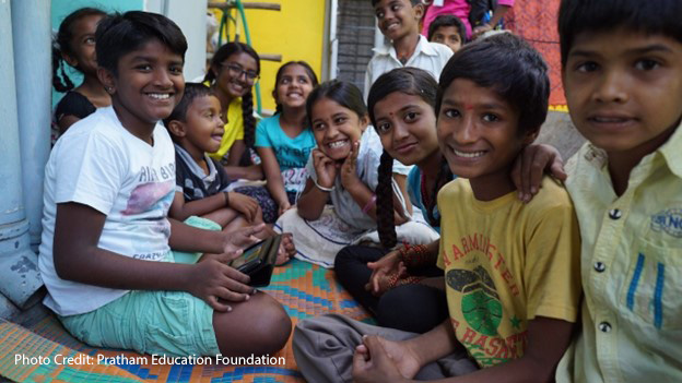 Children in Anekal, Karnataka accessing digital content on a tablet.