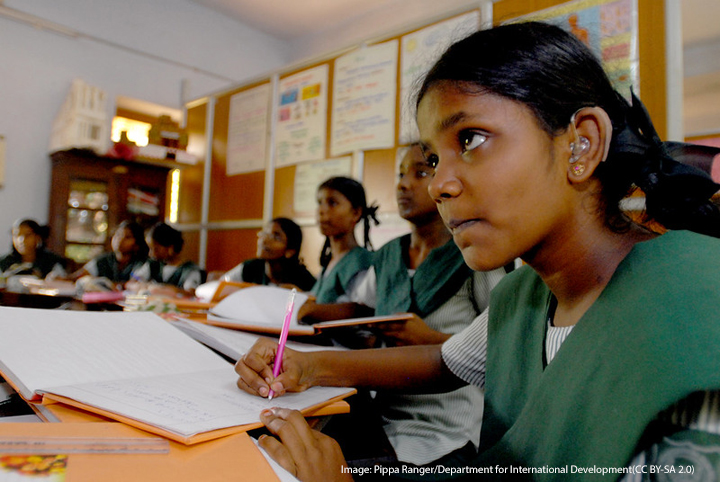 Girls in a classroom in Chennai, India, learning about global issues.