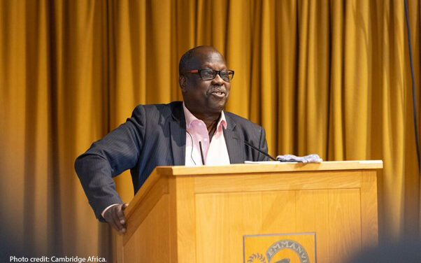 Professor Eugene Ndabaga from the University of Rwanda – College of Education standing at a podium giving a presentation at the Cambridge Africa Day conference on 6 July 2022.