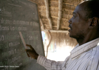 A male teacher points to the blackboard at Betokomia Trois bush school, Central African Republic