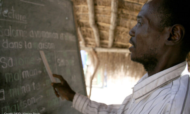 A male teacher points to the blackboard at Betokomia Trois bush school, Central African Republic