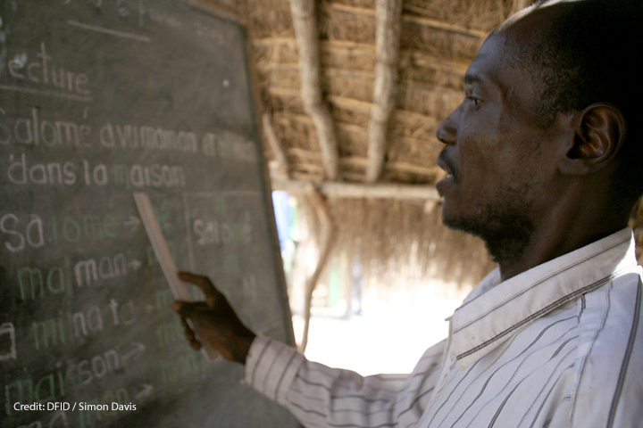 A male teacher points to the blackboard at Betokomia Trois bush school, Central African Republic