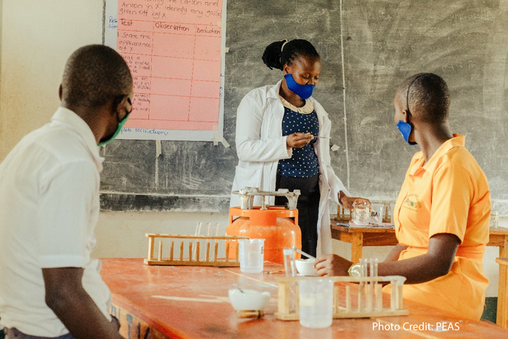 Female teacher giving a science class in a PEAS school, Uganda.