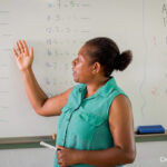 Janet, inclusive education school teacher, teaches maths in front of a white board, Freswota School, Vanuatu.