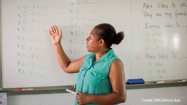 Janet, inclusive education school teacher, teaches maths in front of a white board, Freswota School, Vanuatu.