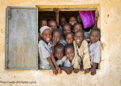 Children from an overcrowded classroom squeeze into a window to try and look out, Janbulo Islamiyya Primary School, Roni, Jigawa State, Nigeria.
