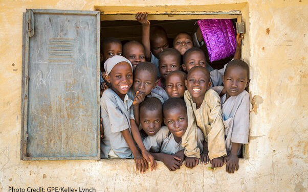 Children from an overcrowded classroom squeeze into a window to try and look out, Janbulo Islamiyya Primary School, Roni, Jigawa State, Nigeria.