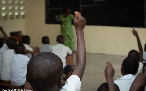 Children raise their hands as teacher Amunazo Belinda gives a lesson at Manua school near Kindu, Maniema province, Democratic Republic of Congo.