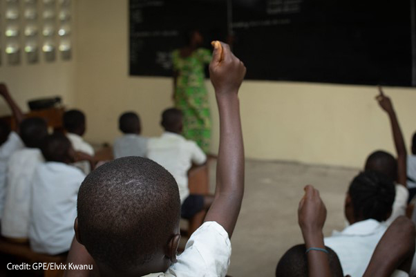 Children raise their hands as teacher Amunazo Belinda gives a lesson at Manua school near Kindu, Maniema province, Democratic Republic of Congo.