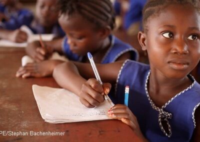 Girls wearing blue uniform writing at desks