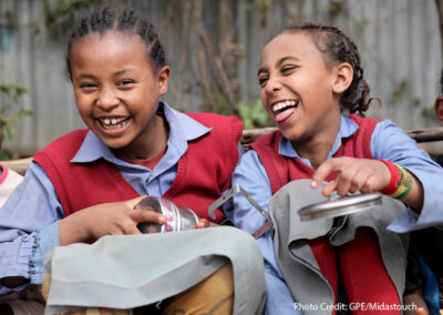 Two girls laughing on their lunchbreak at Hidassie School, Addis Ababa, Ethiopia.