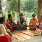 Women gather in a community group to learn about travelling abroad safely. The UK Aid funded Work in Freedom programme works in Nepal, Bangladesh and India to empower women to make the right decision, helping them to avoid exploitation if they decide to go abroad, and assisting them find work locally if they decide not to go. A group of women sitting on the ground in a circle
