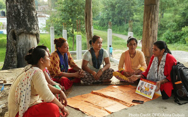 Women gather in a community group to learn about travelling abroad safely. The UK Aid funded Work in Freedom programme works in Nepal, Bangladesh and India to empower women to make the right decision, helping them to avoid exploitation if they decide to go abroad, and assisting them find work locally if they decide not to go. A group of women sitting on the ground in a circle