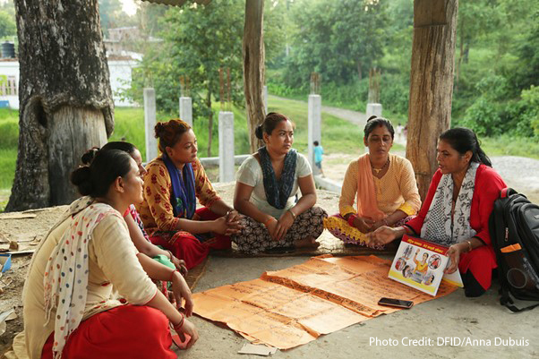 Women gather in a community group to learn about travelling abroad safely. The UK Aid funded Work in Freedom programme works in Nepal, Bangladesh and India to empower women to make the right decision, helping them to avoid exploitation if they decide to go abroad, and assisting them find work locally if they decide not to go. A group of women sitting on the ground in a circle