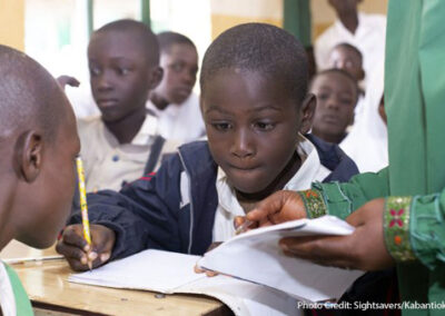 Abdullahi, a boy with partial visual impairment, receives extra support at school in Nigeria, through the Sightsavers SMILE project.