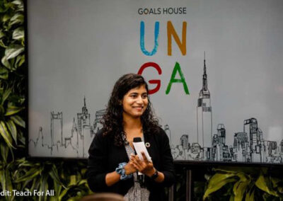 Shruti Belitkar speaks at the Transforming Education Summit in September 2022, in front of an UNGA banner.