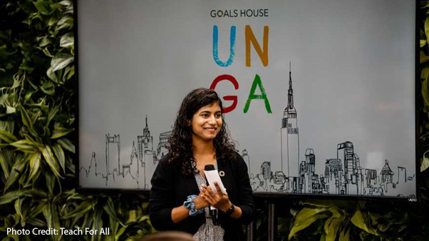 Shruti Belitkar speaks at the Transforming Education Summit in September 2022, in front of an UNGA banner.