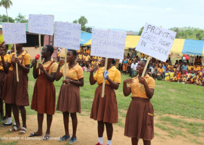 Girls in school in Ghana mobilising for their rights. Holding placards with Rights to school and clean environment