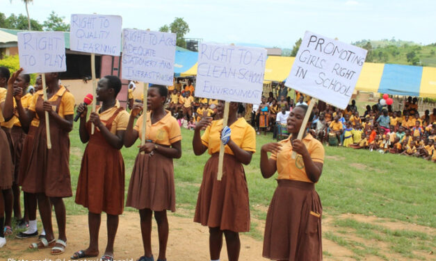 Girls in school in Ghana mobilising for their rights. Holding placards with Rights to school and clean environment