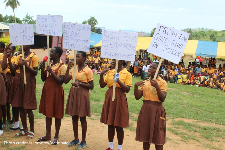 Girls in school in Ghana mobilising for their rights. Holding placards with Rights to school and clean environment