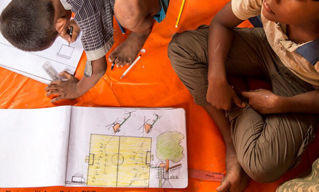 Rohingya children sitting on the floor drawing pictures of what they witnessed in Myanmar. They are at a UNICEF child friendly space at Batukhali refugee camp in Bangladesh, where art therapy and counselling help Rohingya children recover from the trauma they have experienced.