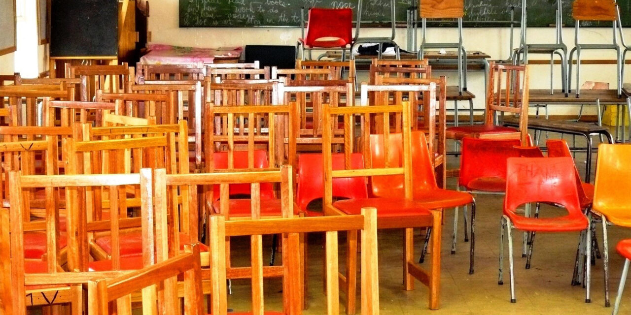 A classroom during school closures from COVID-19, empty of students and full of chairs.