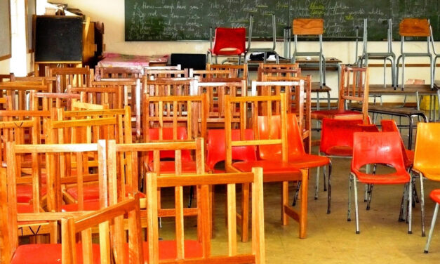 A classroom during school closures from COVID-19, empty of students and full of chairs.