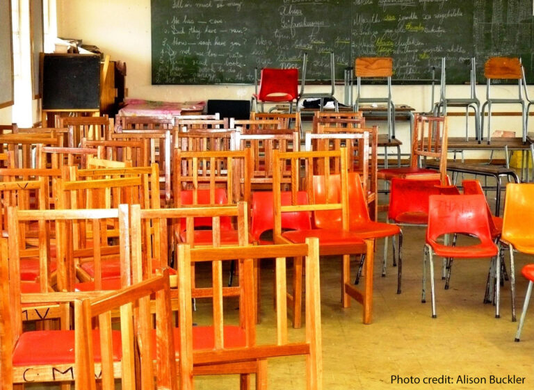 A classroom during school closures from COVID-19, empty of students and full of chairs.