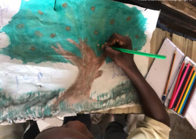 Young boy draws a tree through a photovoice project, Lake Chad region.