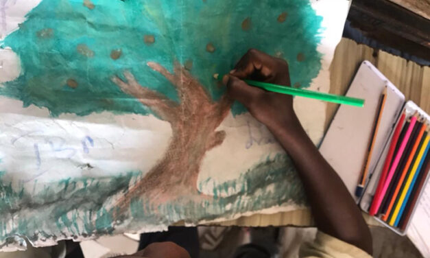 Young boy draws a tree through a photovoice project, Lake Chad region.