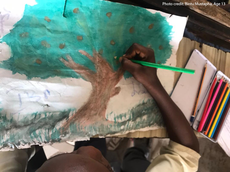 Young boy draws a tree through a photovoice project, Lake Chad region.