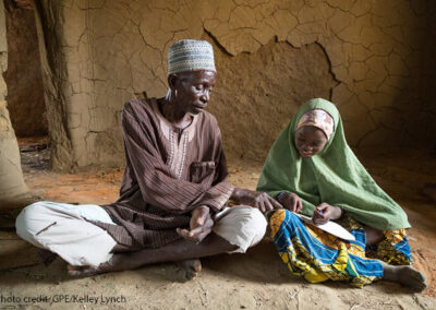 Grandfather and village chief Mai Unguwa Ali Abdullahi sits with his granddaughter Mariam Isah, 8, in Nigeria. The village chief wants his granddaughter to become a doctor or nurse to help her community but Mariam wants to become a teacher to help other children learn.