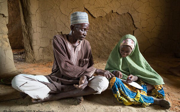 Grandfather and village chief Mai Unguwa Ali Abdullahi sits with his granddaughter Mariam Isah, 8, in Nigeria. The village chief wants his granddaughter to become a doctor or nurse to help her community but Mariam wants to become a teacher to help other children learn.